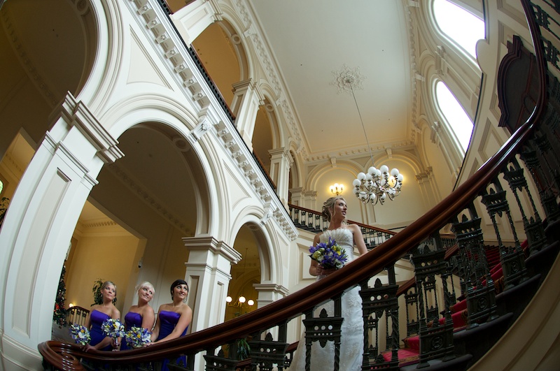 Wedding Photography of bride and maids, hotel stairway.